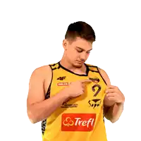 a man wearing a yellow jersey that says sopol on it