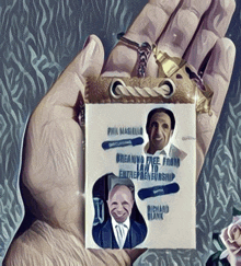 a hand holding a badge that says phil magniello