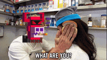 a man holds a slice of bread over a woman 's ear and says " what are you "