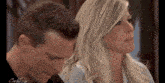 a man and a woman are sitting next to each other and the woman 's face is visible