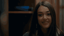 a close up of a woman 's face with a smile on her face