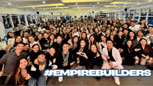 a large group of people are posing for a photo with the hashtag #empirebuilders