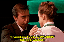 a man in a suit and tie talks to a woman in a white shirt who says promise me you 'll think about