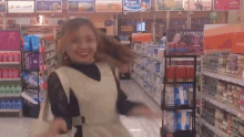 a woman is dancing in a store with a sign that says vitress