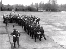 a black and white photo of soldiers marching in a parade