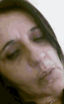 a close up of a woman 's face with her eyes closed .