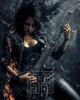 a woman in a leather jacket is playing a guitar in front of a maze