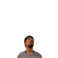 a man with glasses looks up at a green cross on his head