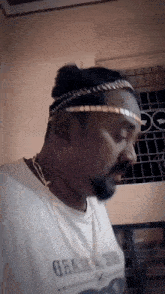 a man wearing a headband and a shirt that says ' brazil ' on it