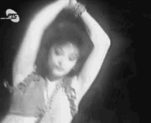 a woman is dancing in a black and white photo with a watermark that says ' ntv ' on it