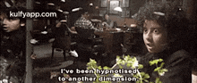 a boy is talking about being hypnotised to another dimension in a restaurant .
