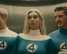 a woman in a fantastic four costume is standing next to two men