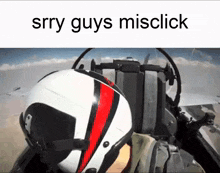 a man wearing a helmet is sitting in a plane .
