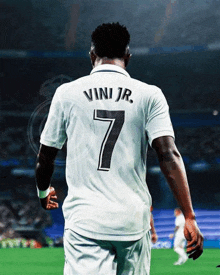 a soccer player wearing a white jersey with the number 7 on it