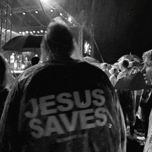 a person wearing a raincoat that says jesus saves on it