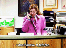 a woman in a pink coat talking on a phone with the words i don 't know it felt far below her