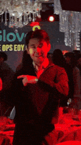 a man is dancing in front of a sign that says slov ops eoy