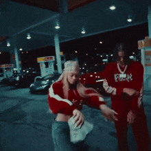 a woman wearing a red jacket with the letter f on the front
