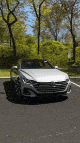 a silver volkswagen car is parked in a parking lot