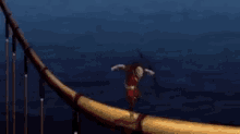 a man with a bow and arrow is flying through the air .