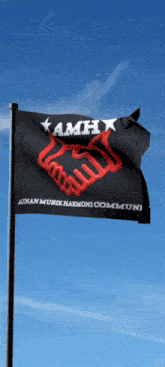 a black flag with a red handshake on it says kamh