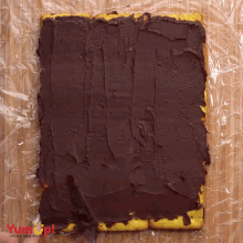 a piece of food with chocolate spread on it is covered in plastic