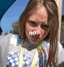a young girl wearing a lanyard that says no
