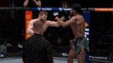 a man in a ufc glove is kicking another man