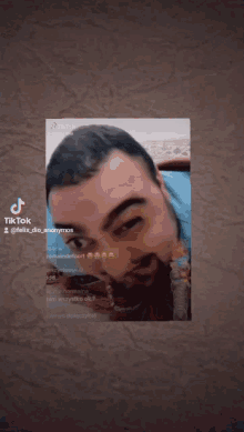a man 's face is displayed on a tiktok page