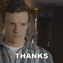 a man in a plaid shirt says thanks in white