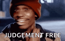 a man wearing a red hat is smiling with the words judgement free written on the bottom