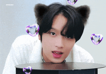 a boy with cat ears and hearts around him