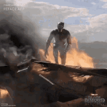 a man in a black panther suit is standing on top of a burning building .