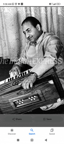 a man is playing an accordion in a black and white photo