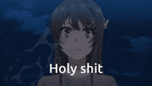 a girl with a flower in her hair is standing in front of a blue background with the words holy shit .
