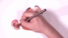 a person is drawing a cow 's ear with a pencil .