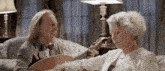 a man is playing a guitar for an elderly woman who says haarald
