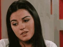 a close up of a woman 's face with long black hair