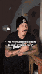 a man with a beanie on says " this new kendrick album doesn 't even go hard "