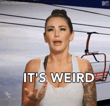 a woman says it 's weird while standing in front of a ski lift