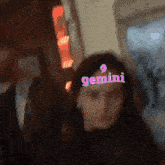 a blurry picture of a woman with the word gemini on her forehead