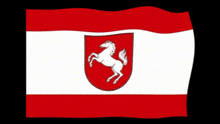 a red and white flag with a horse on a shield
