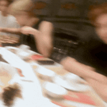 a blurry picture of people sitting around a table