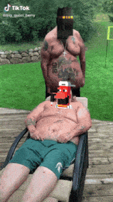 a man with a tattoo on his chest that says " big "
