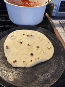 a tortilla is sitting on a pan on a stove