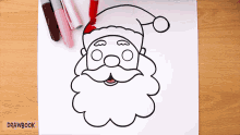 a drawing of santa claus is on a piece of paper with drawbook written below it