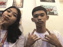 a boy and a girl are posing for a picture and the girl is wearing a medal that says " basketball "