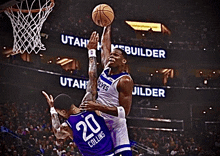 a basketball player with the number 20 on his jersey is jumping for the ball