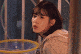 a young woman looking out a window with a bubble in the background