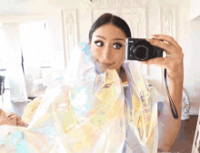 a woman is taking a picture of herself in a mirror